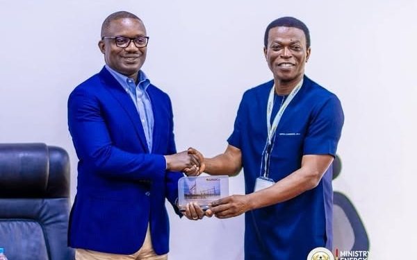 John Jinapor shaking hands with Mr. Edmond Kombat, TOR MD